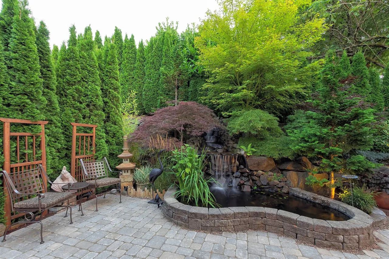 Paver patio and planted pond garden after landscaping