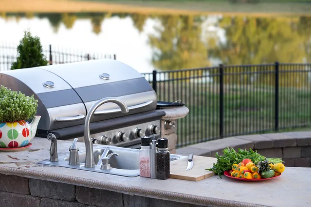 Outdoor kitchen with built-in grill overlooking the water