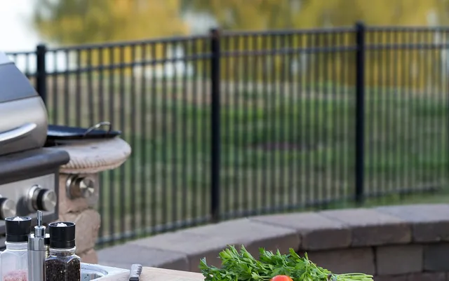 Built-in grill and stone counter at an outdoor kitchen