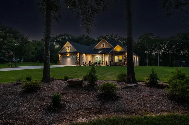 Manicured lawn and landscape lighting at dusk