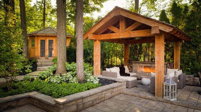 Timber garden pavilion set in a shaded woodland landscape